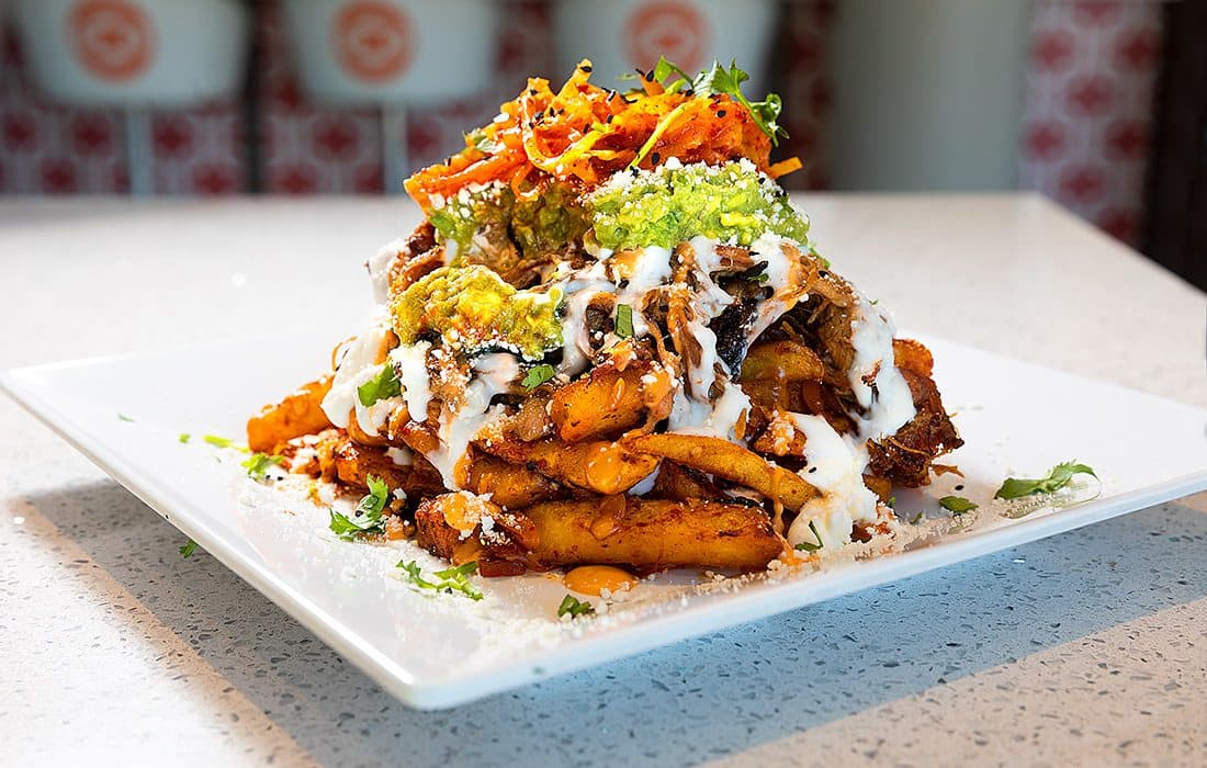 Close up photo of Wheelhouse Kimchi Fries on a plate.